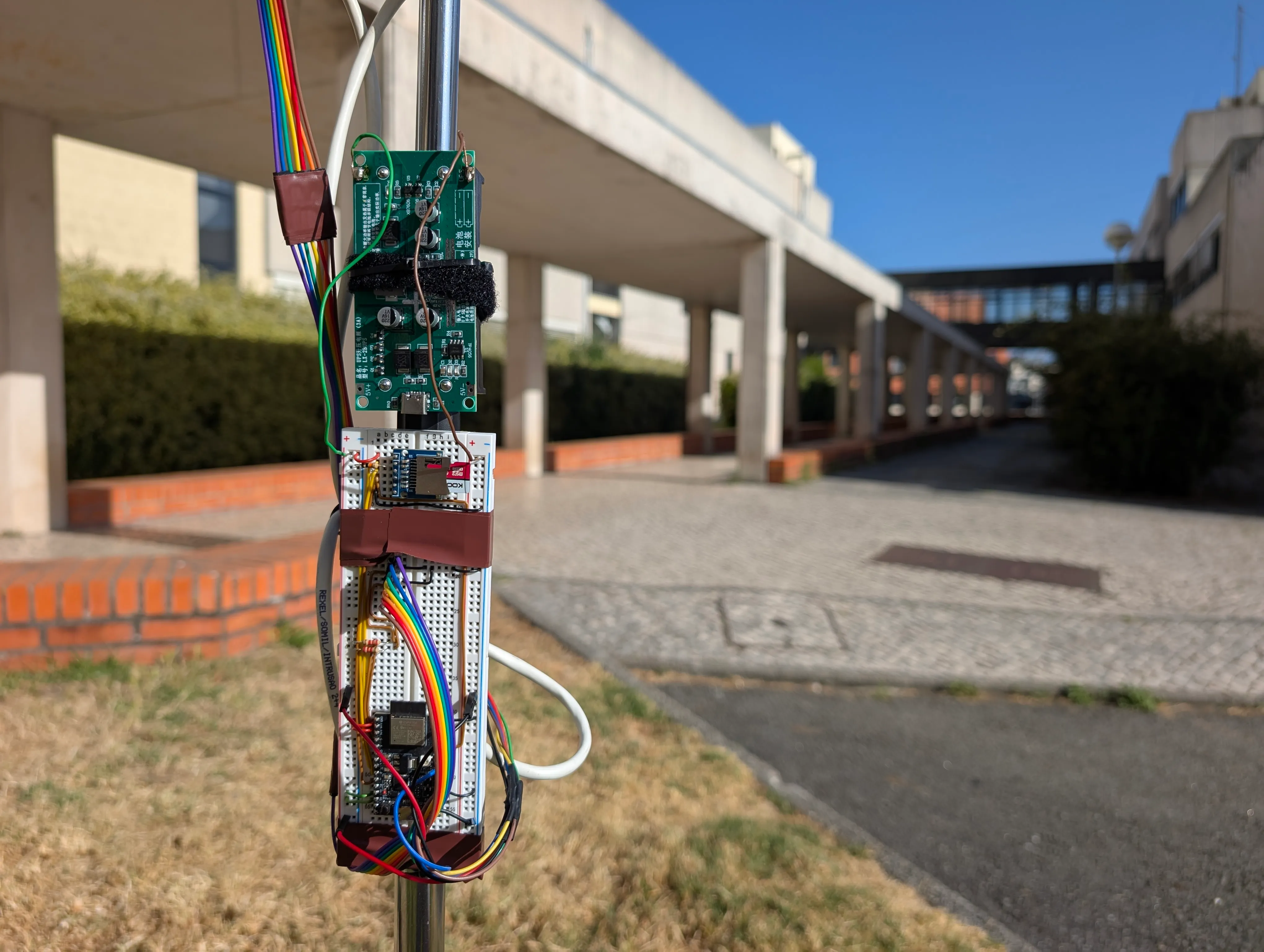 The ESP32, microSD reader, wiring, and battery UPS module mounted on the station's mast